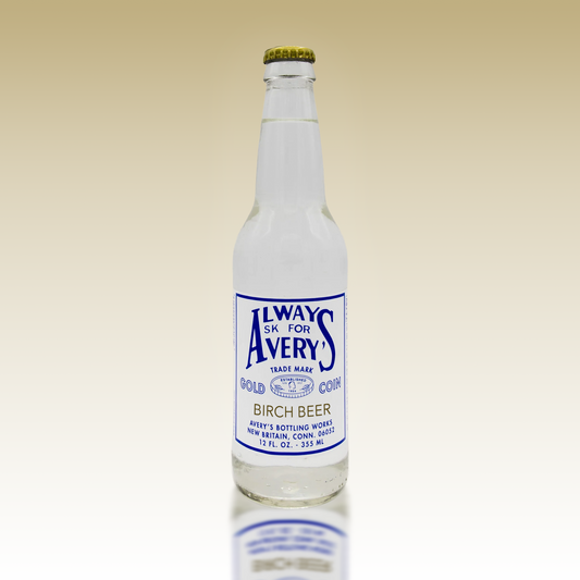 Avery's Birch Beer in glass bottle on beige gradient background