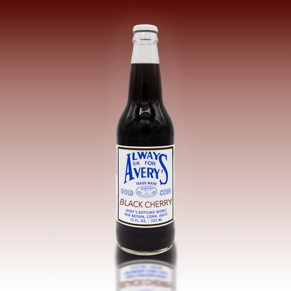 Avery’s Black Cherry Soda in glass bottle on deep red gradient background