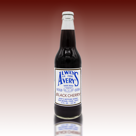 Avery’s Black Cherry Soda in glass bottle on deep red gradient background