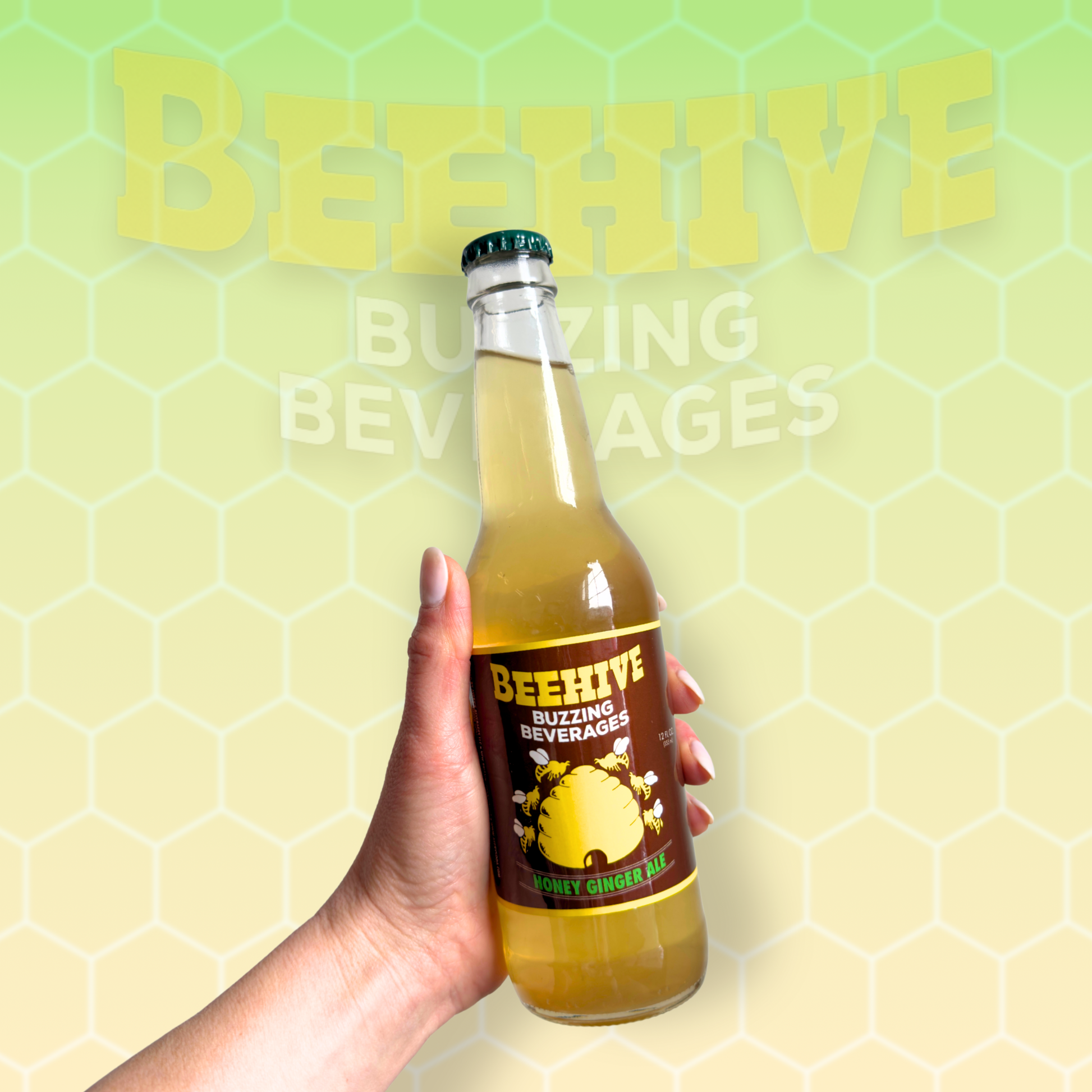 Hand holding a bottle of Avery’s Honey Infused Ginger Ale in glass bottle on yellow and green gradient background