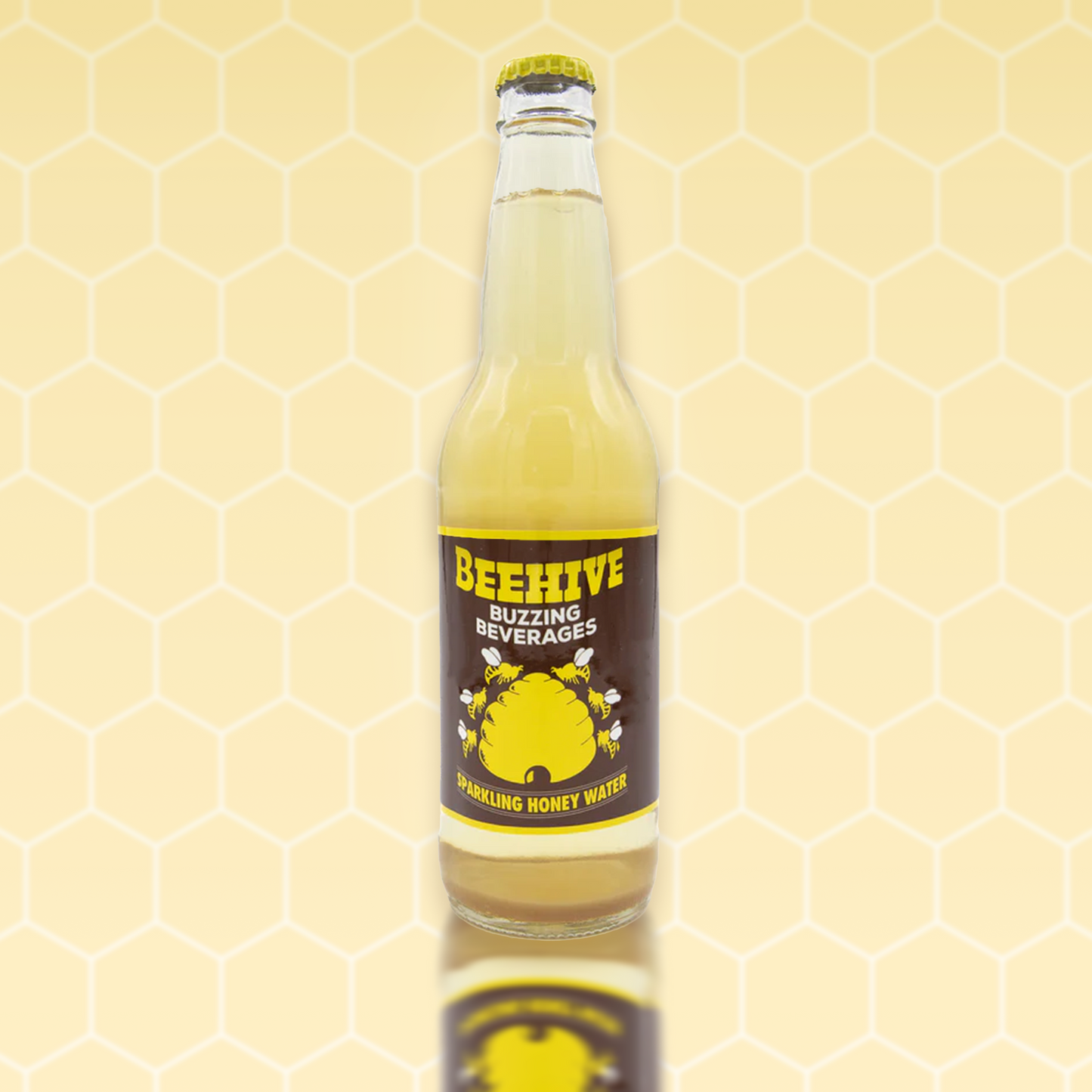 Avery’s Honey Infused Sparkling Honey Water in glass bottle on yellow honeycomb background