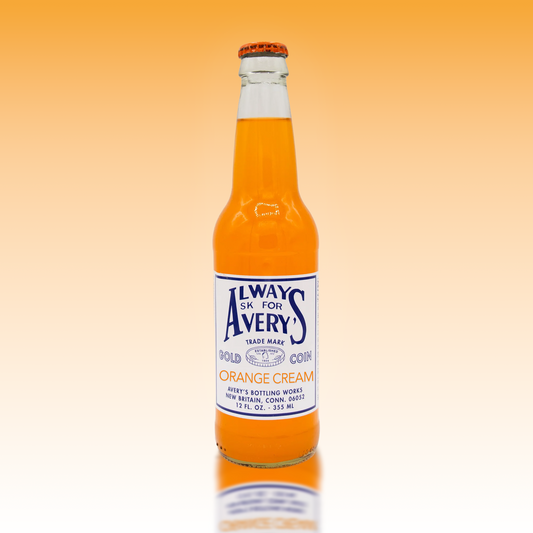 Avery's Orange Cream Soda in glass bottle on orange gradient background