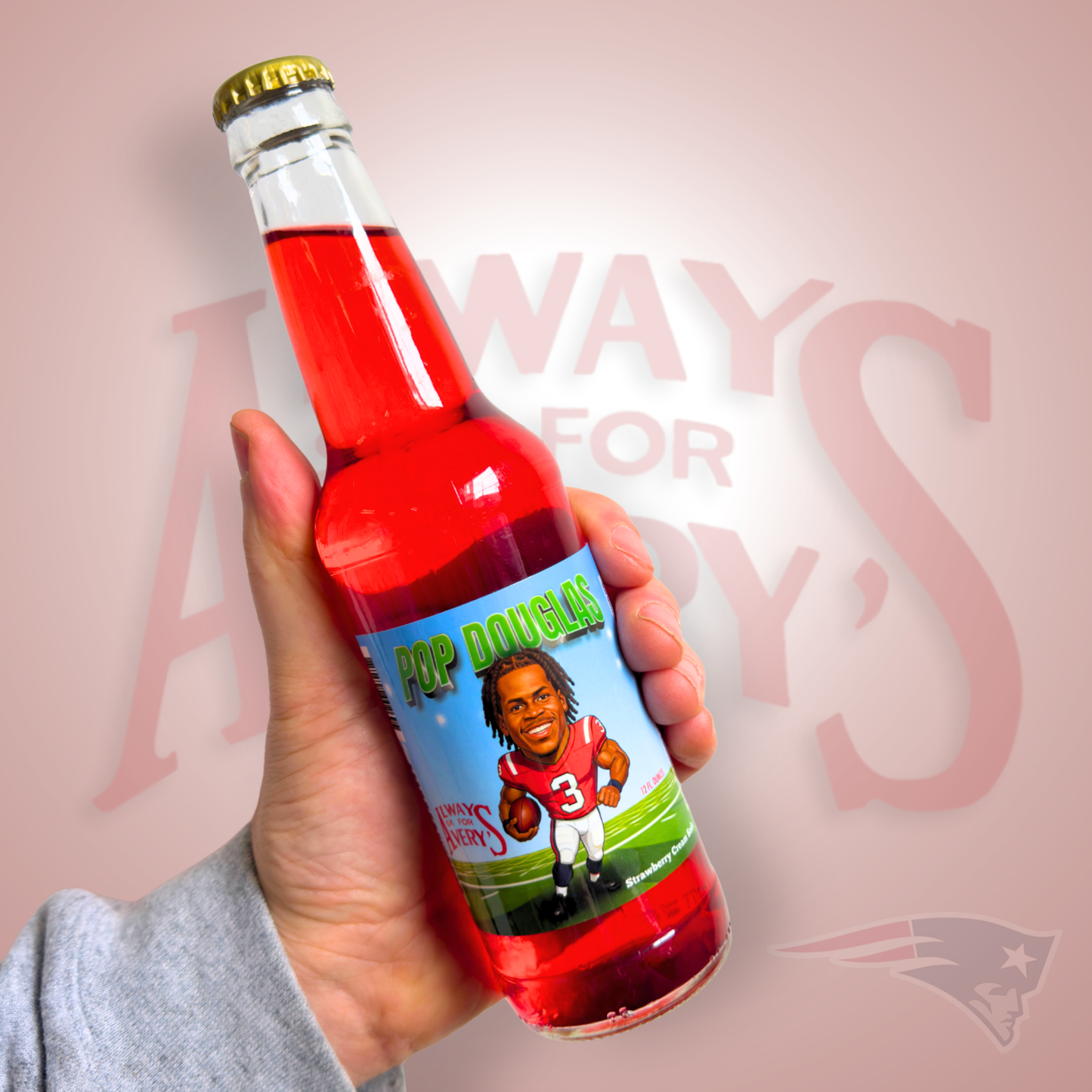 Hand holding a bottle of Avery's Pop Douglas Strawberry Cream Soda in glass bottle on red gradient background with New England Patriots logo