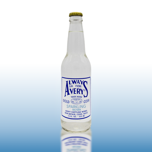 Avery’s Sparkling Seltzer in glass bottle on blue gradient background