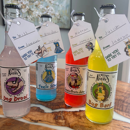 Avery's Totally Gross gifting tags hanging from colorful glass bottles with to and from names handwritten on the tags