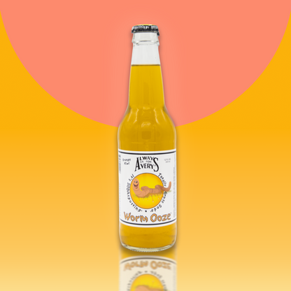 Avery's Totally Gross Worm Ooze Original orange soda in glass bottle on orange gradient background