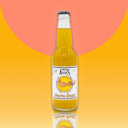 Avery's Totally Gross Worm Ooze Original orange soda in glass bottle on orange gradient background